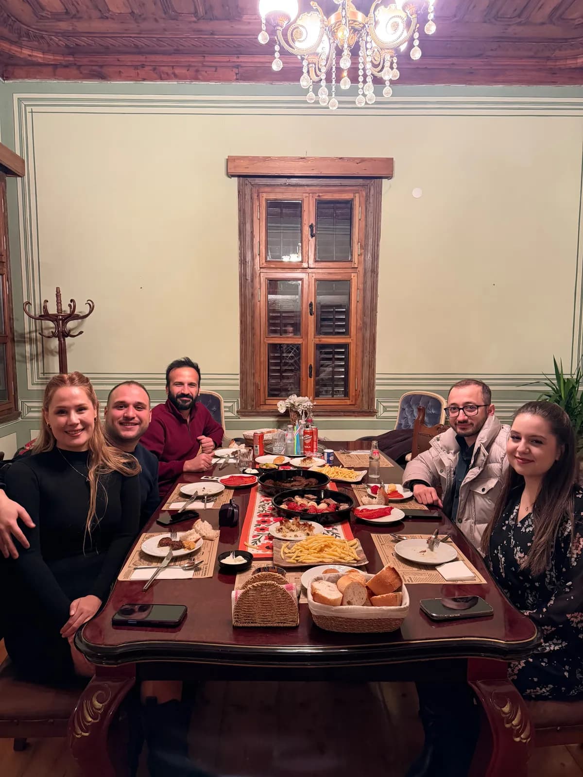 A celebration dinner with friends after a marriage proposal in the lounge of the guesthouse in Edirne